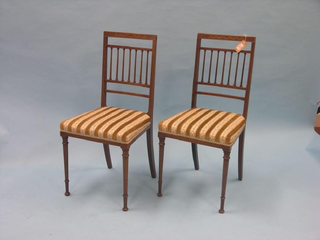 Appraisal: A pair of Edwardian inlaid mahogany side chairs with spindle-backs