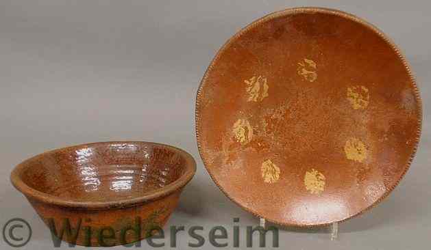 Appraisal: Pennsylvania redware plate with yellow slip decoration diam and a