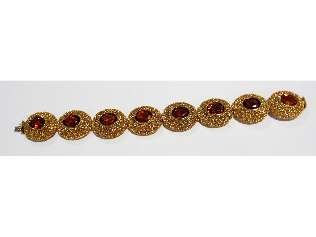 Appraisal: An eighteen carat gold Cairngorm set bracelet with eight oval