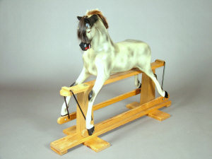 Appraisal: A Haddon Rocking Horse dapple grey on light oak stand