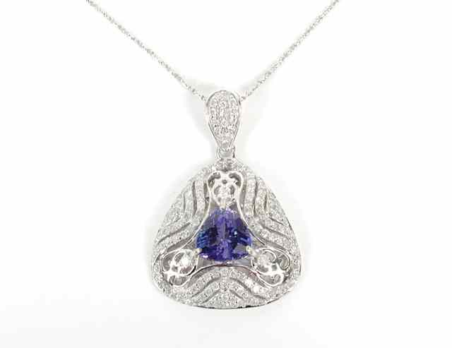 Appraisal: TANZANITE AND DIAMOND PENDANT NECKLACE suspended on an inch chain