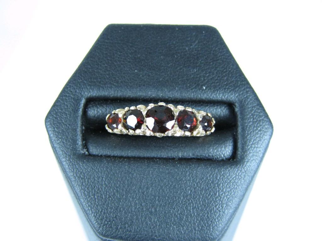 Appraisal: A Garnet five stone Ring pav -set graduated cushion shaped