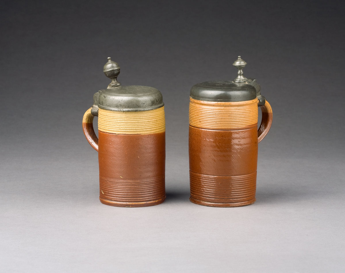 Appraisal: TWO GERMAN BROWN-GLAZED EARTHENWARE PEWTER-MOUNTED TANKARDS Each with threaded ends