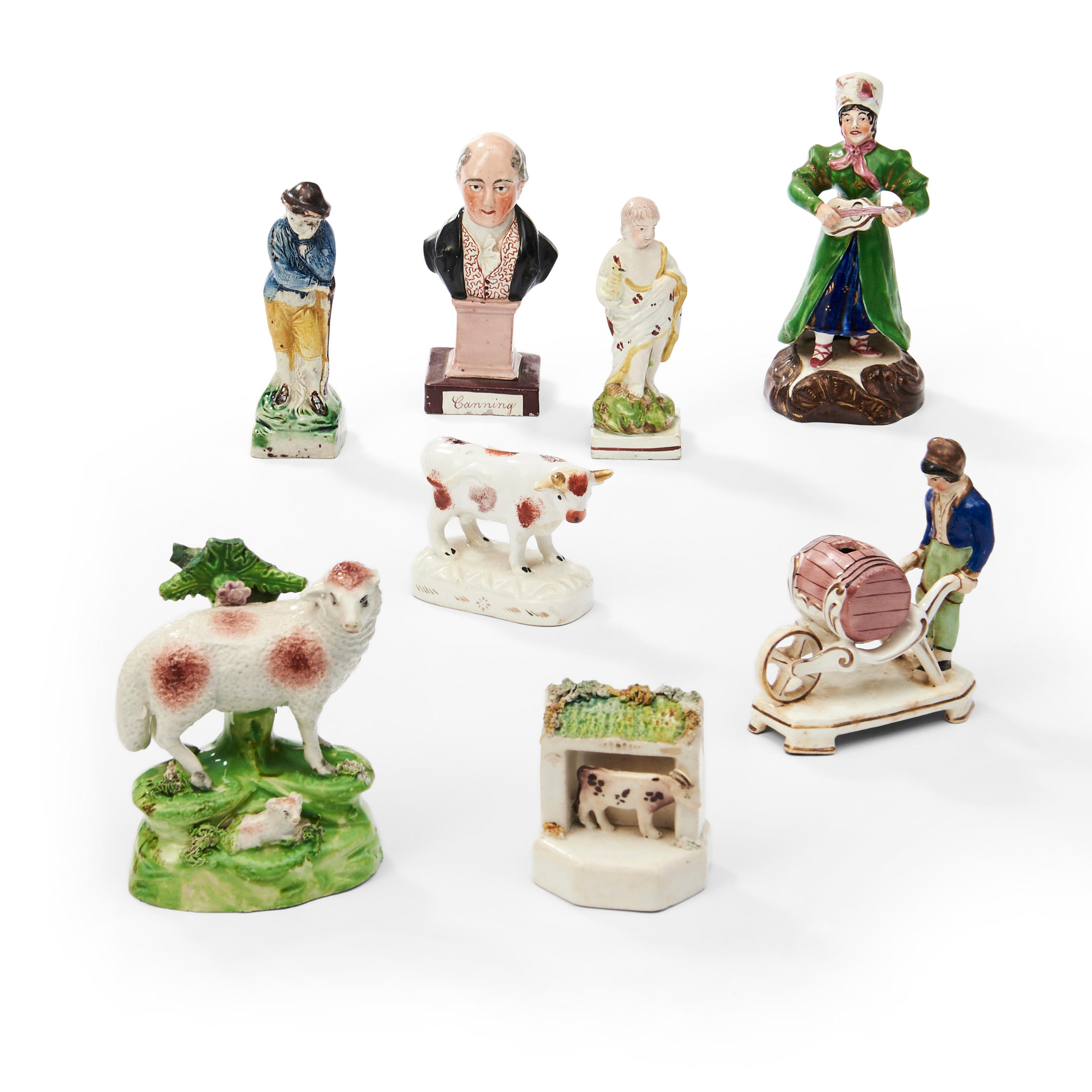 Appraisal: EIGHT STAFFORDSHIRE POTTERY FIGURES including a sheep a cow a