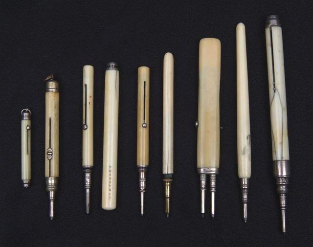 Appraisal: AN IVORY DOUBLE SLIDE PENCIL and six other ivory slide