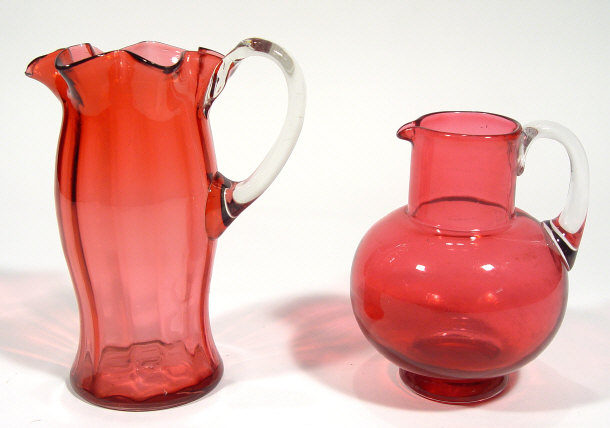 Appraisal: Two cranberry glass jugs one of fluted form the other