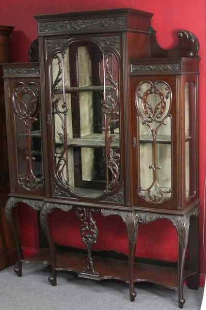 Appraisal: An Edwardian mahogany display cabinet with elaborate moulding to the