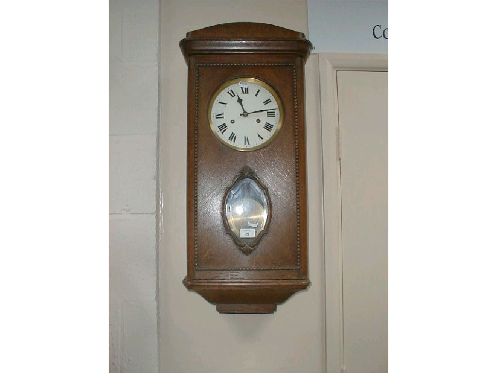 Appraisal: A 's oak cased wall clock with enamelled dial and