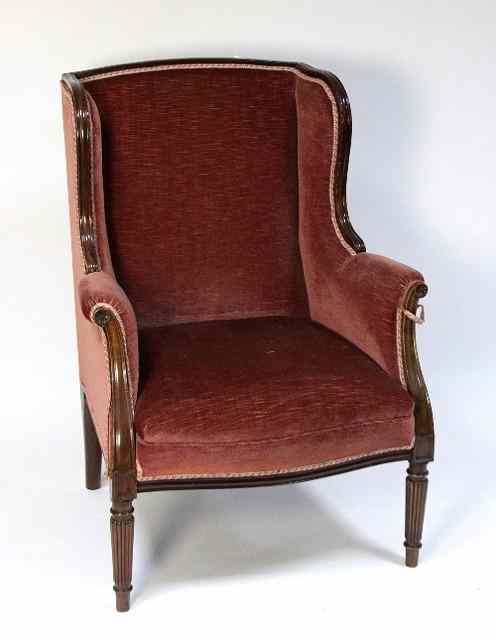 Appraisal: A Louis XV style wing armchair on turned legs