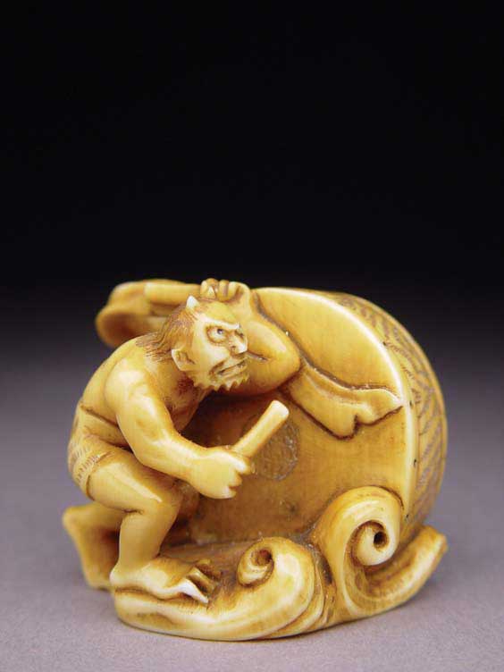 Appraisal: CARVED IVORY NETSUKE Contemporary stained and well carved ivory netsuke