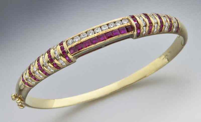 Appraisal: K gold diamond and ruby bangle braceletfeaturing princess and modified