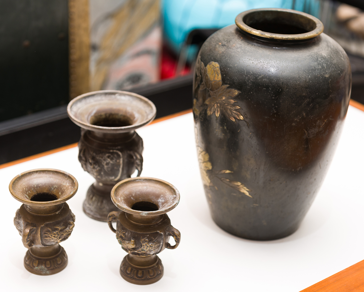 Appraisal: A JAPANESE ENAMELLED VASE AND THREE SMALL DECORATIVE BRASS URNS