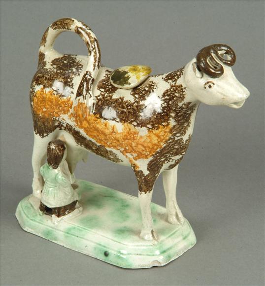 Appraisal: An English pearlware cow-creamer Staffordshire or Yorkshire typically modelled being