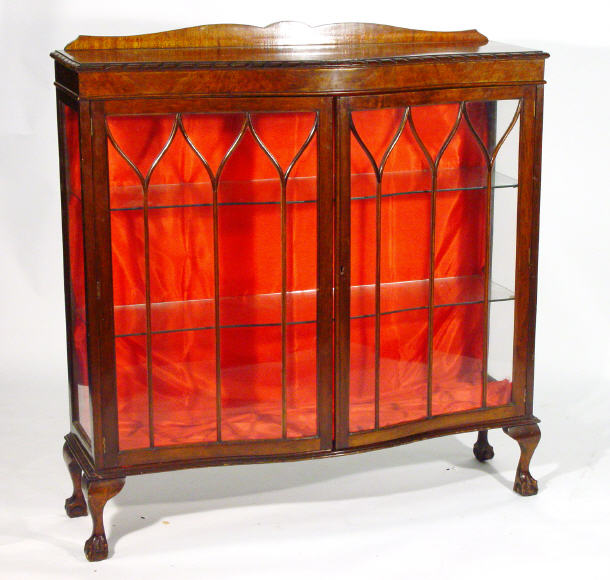 Appraisal: Edwardian serpentine fronted mahogany china cabinet with cloud shaped pediment