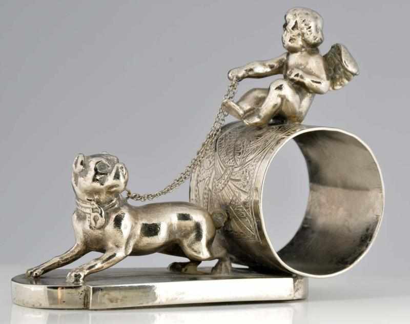 Appraisal: Winged Cherub Figural Napkin Ring Winged cherub atop napkin holder