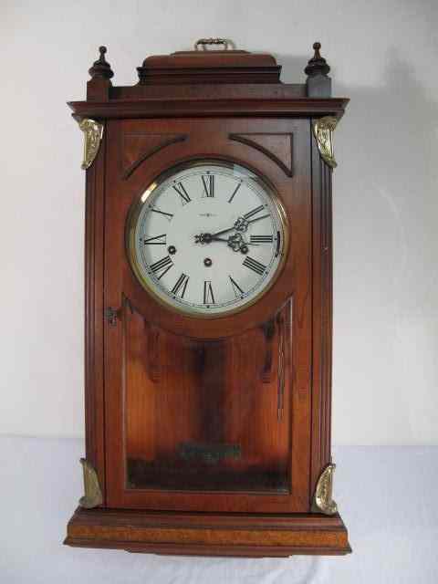 Appraisal: Howard Miller mahogany hanging wall clock Brass accents on front