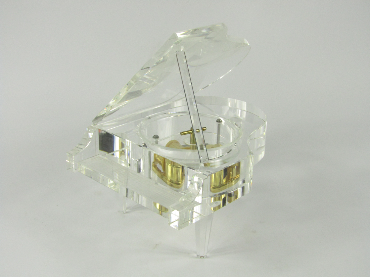 Appraisal: A crystal cased music box modelled as a grand piano