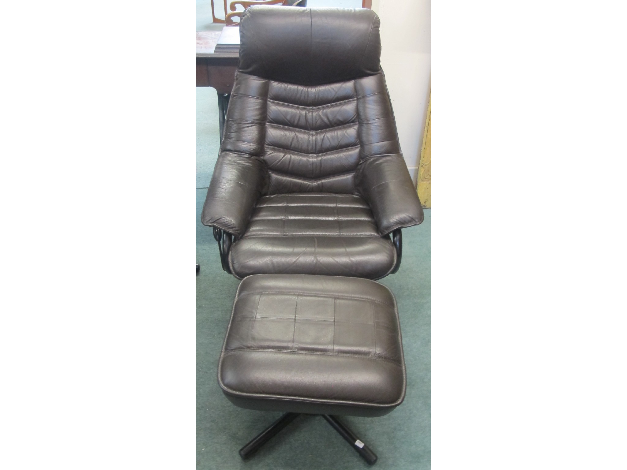 Appraisal: A leather swivel chair and foot stool