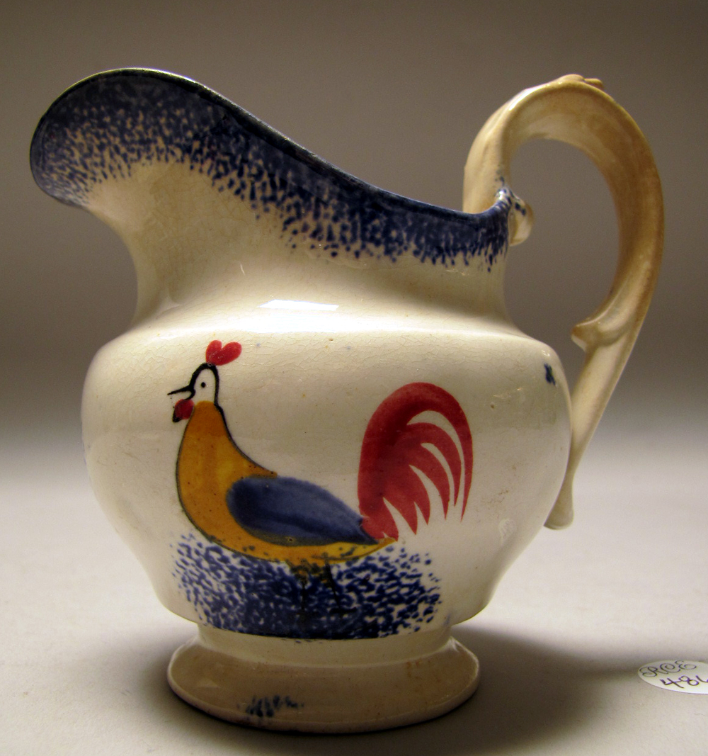 Appraisal: SPATTERWARE CREAMER th CenturyWith rooster decoration and blue spatter Height