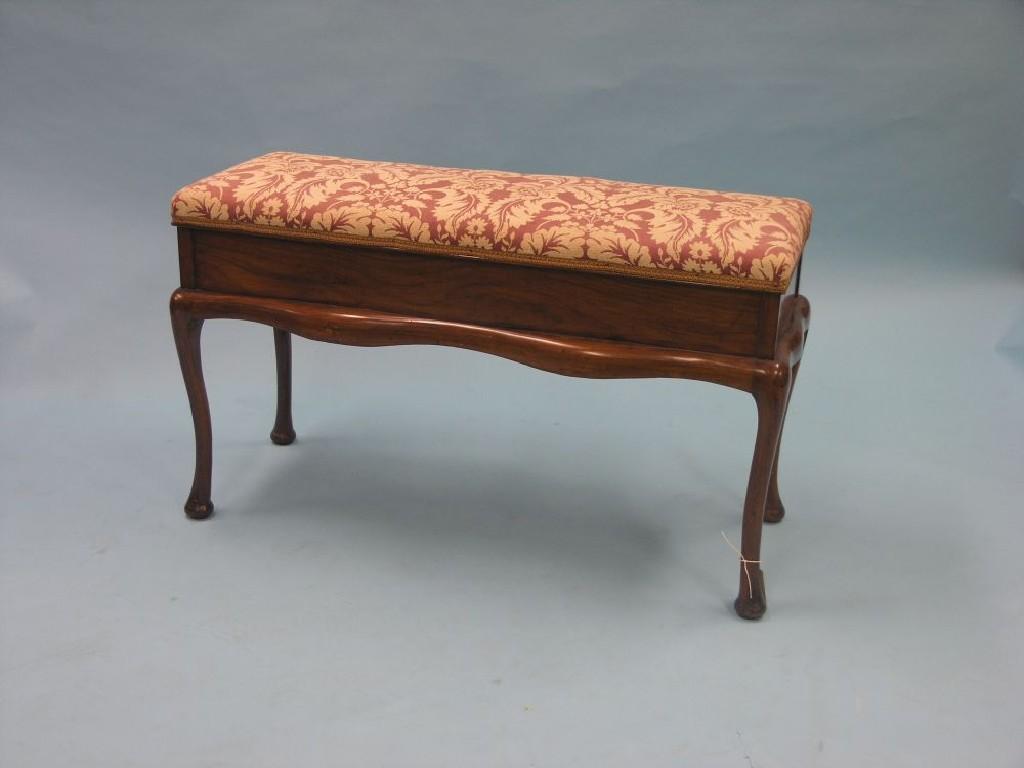 Appraisal: A late Victorian walnut duet stool with hinged upholstered seat