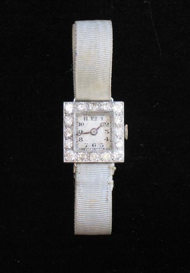 Appraisal: AN EDWARDIAN LADY'S DIAMOND COCKTAIL WATCH the square white dial