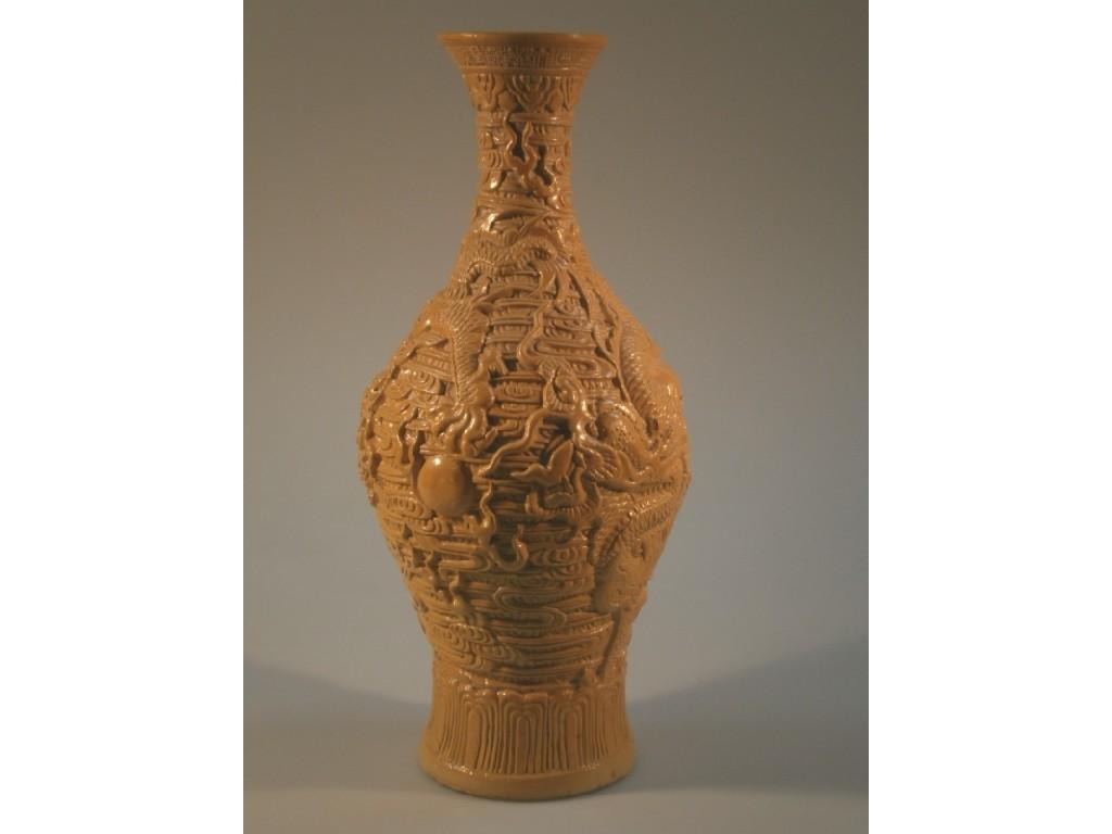 Appraisal: A Chinese stoneware relief moulded dragon vase decorated with yellow