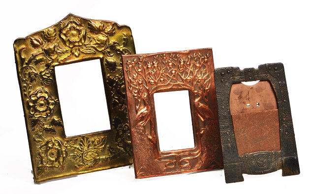 Appraisal: AN ARTS AND CRAFTS EMBOSSED COPPER PICTURE FRAME decorated with