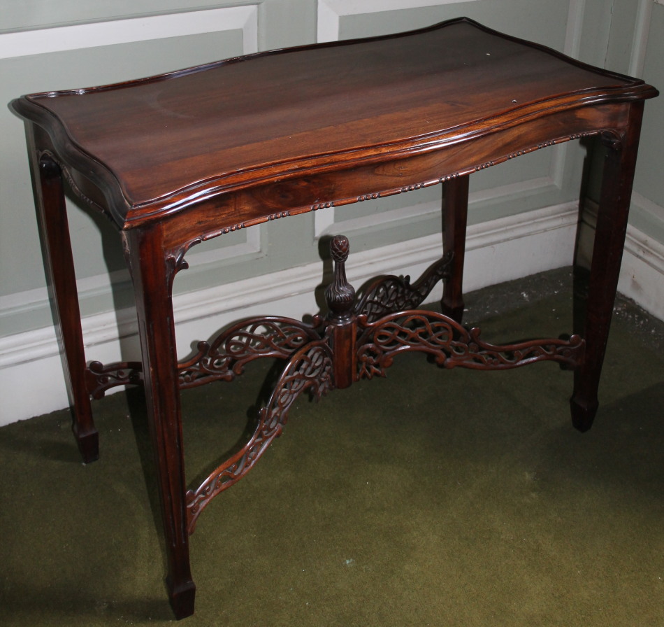 Appraisal: A modern mahogany table in Chippendale style the shaped top