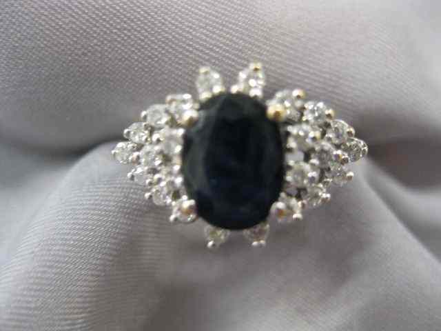 Appraisal: Sapphire Diamond Ring deep blue oval gem weighing carat surrounded