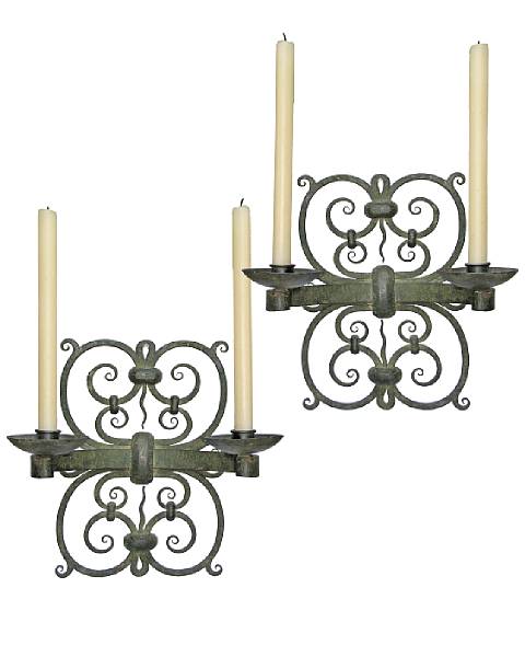 Appraisal: A pair of French patinated wrought iron two light sconces