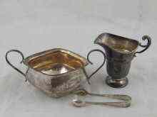 Appraisal: A silver helmet cream jug Birmingham a silver sugar bowl