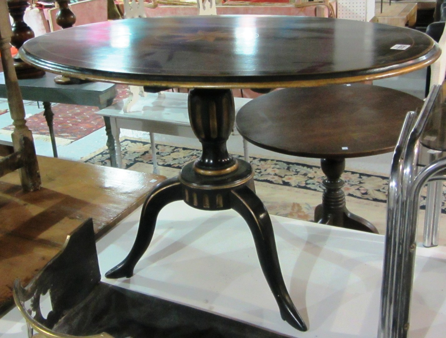 Appraisal: An ebonised and parcel gilt oval snap top table on