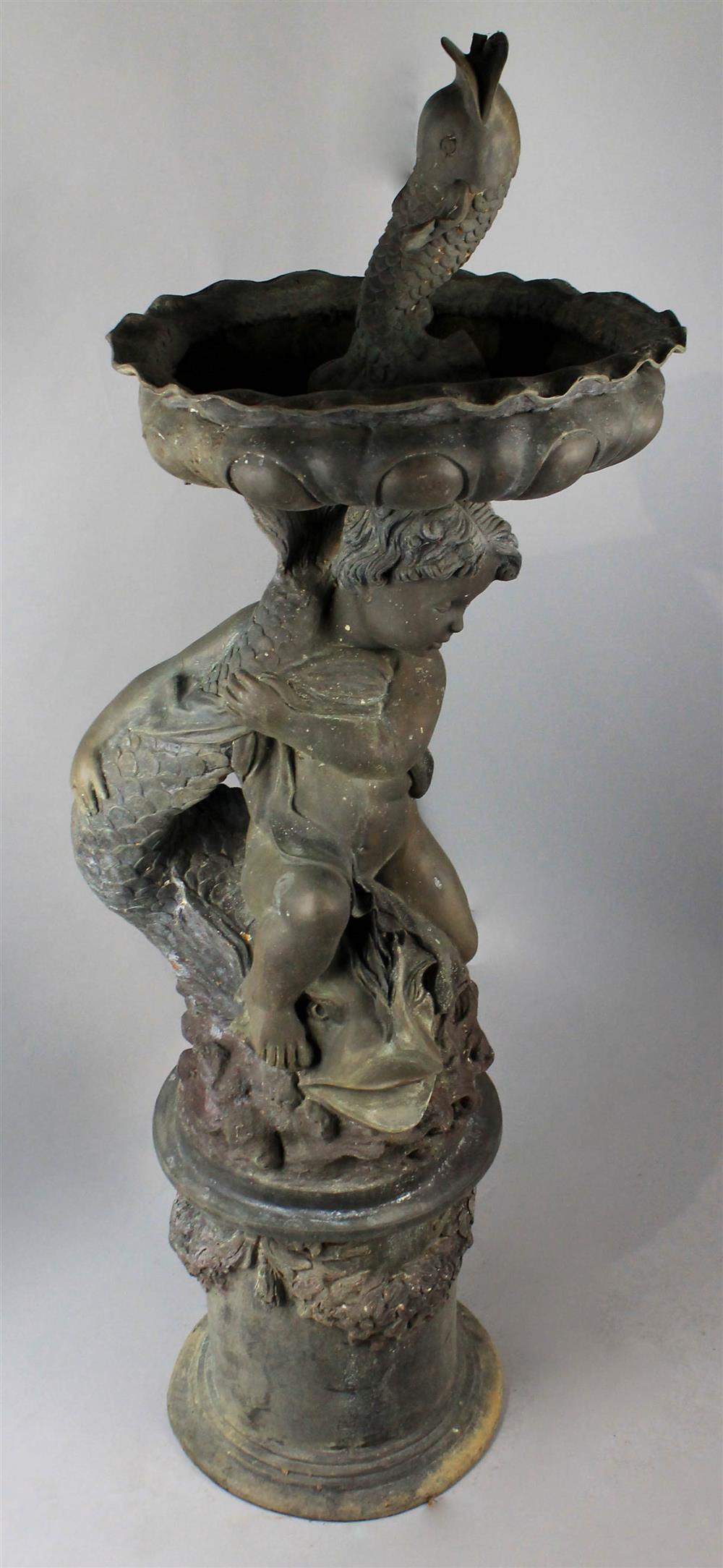 Appraisal: LEAD FOUNTAIN OF A PUTTO straddling a fish surmounted by