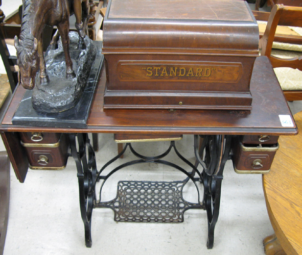 Appraisal: MAHOGANY AND CAST-IRON TREADLE SEWING MACHINE The Standard Sewing Machine