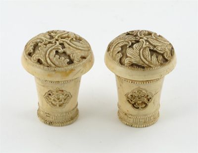 Appraisal: A pair of Chinese ivory scroll ends carved with panels