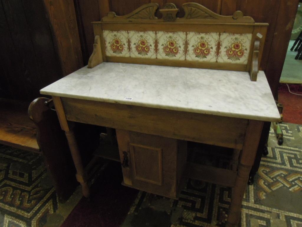 Appraisal: An Edwardian stripped walnut marble top washstand with raised transfer