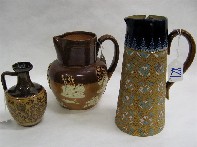 Appraisal: THREE DOULTON LEMBETH POTTERY JUGS One a syrup jug blue