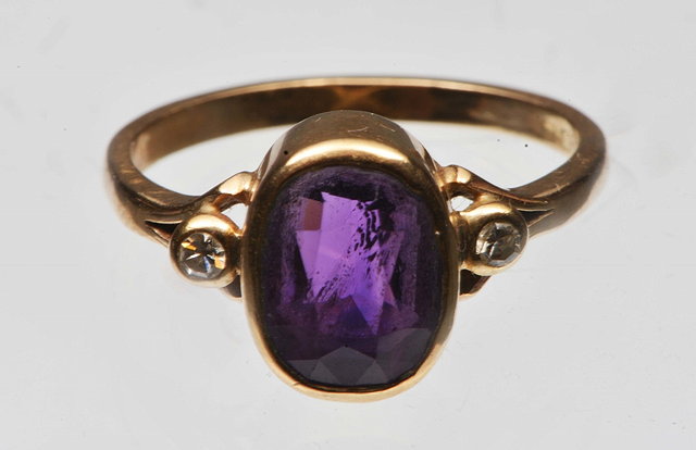 Appraisal: AN AMETHYST AND DIAMOND SET DRESS RING oval facet cut