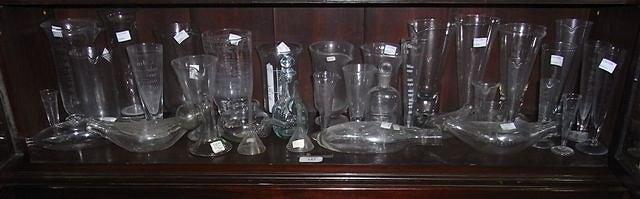 Appraisal: A COLLECTION OF GLASS ETCHED MEASURES flasks glass feeders a