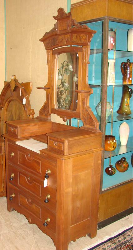 Appraisal: DRESSER WITH MIRROR Walnut with a carved and incised crest