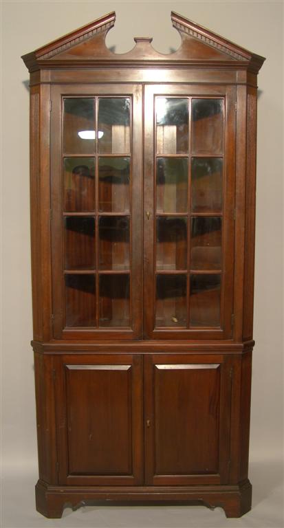 Appraisal: GEORGE III STYLE MAHOGANY CORNER CABINET Surmounted by a broken