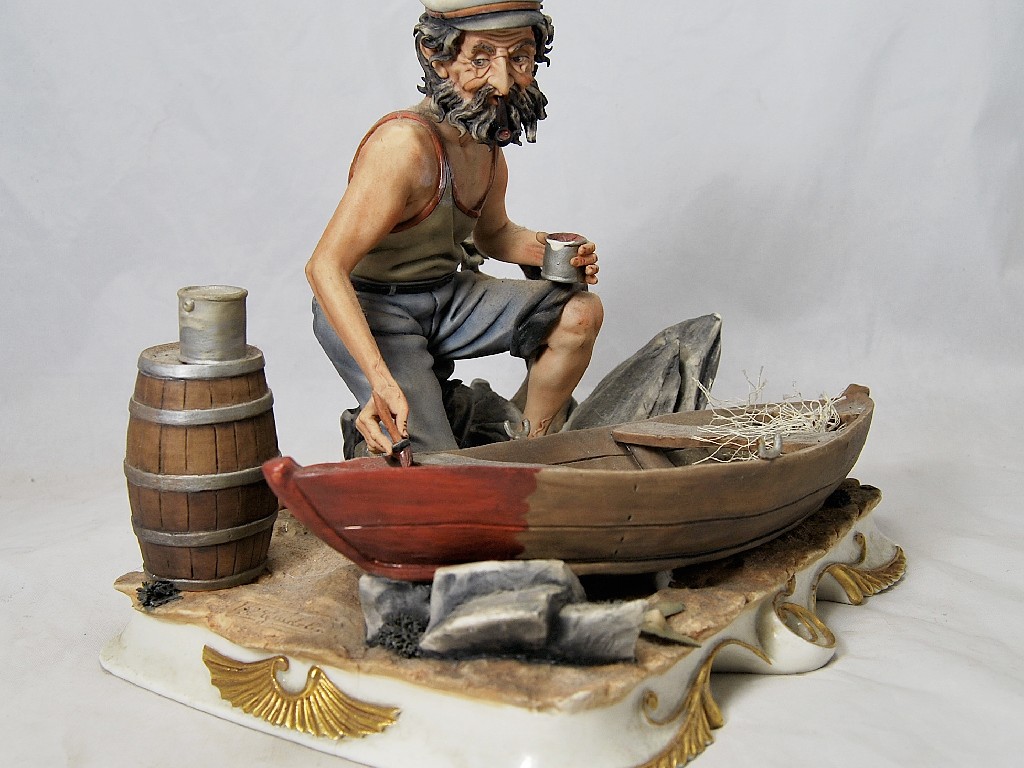 Appraisal: Capo di Monte figure of fisherman painting a rowing boat