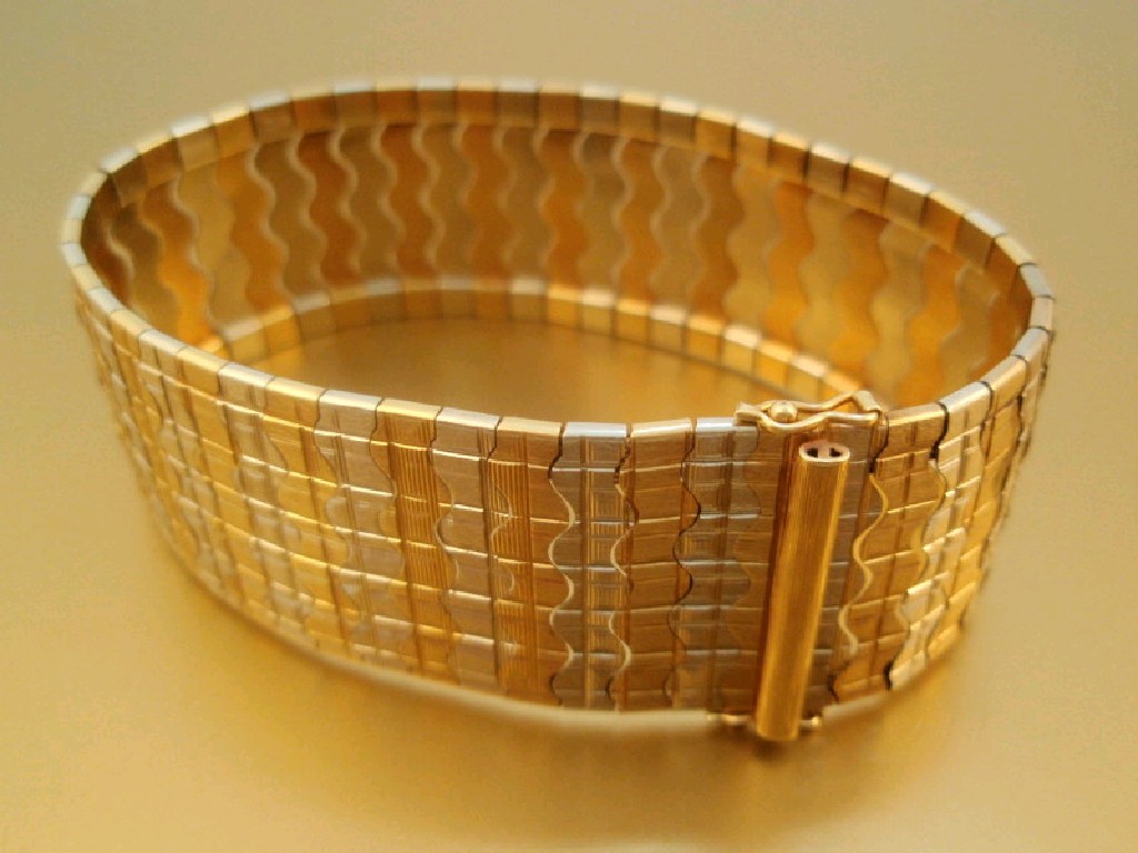 Appraisal: A bi-colour metal cuff bracelet stamped g