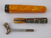 Appraisal: A large amber cheroot holder with niello silver band marked