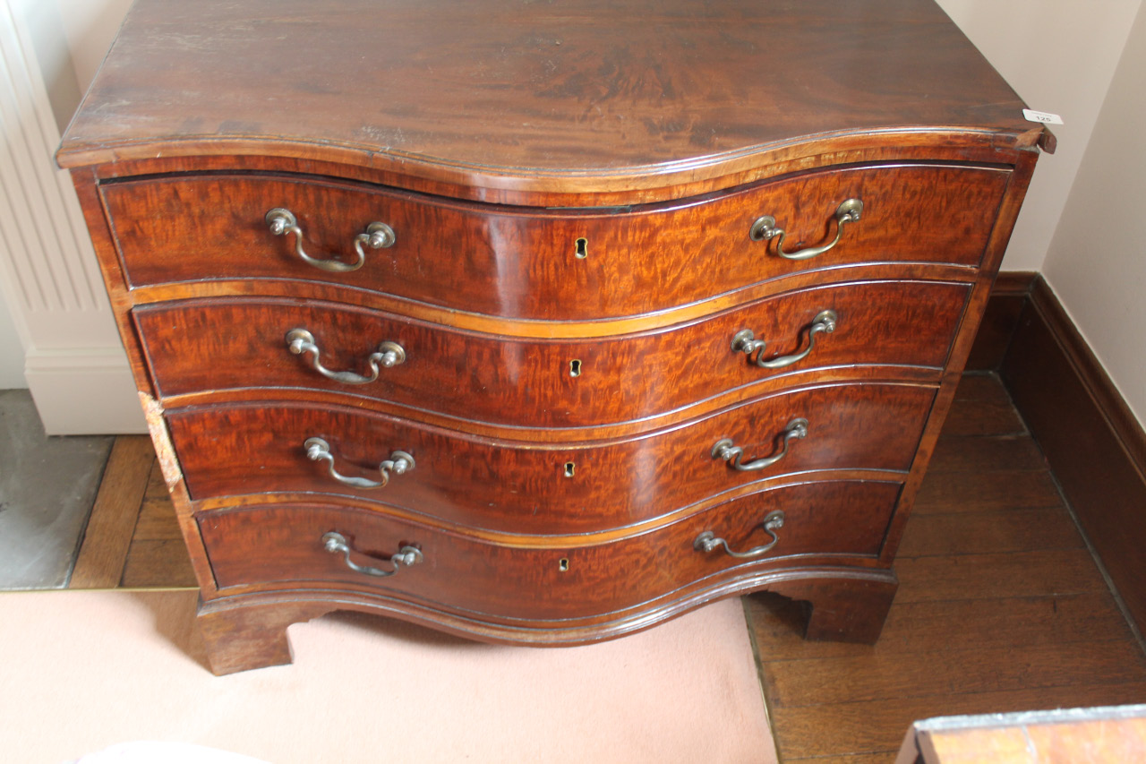 Appraisal: A George III serpentine chest of four graduated drawers with