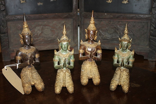 Appraisal: A COLLECTION OF FOUR EASTERN BRONZE FIGURES showing characters praying