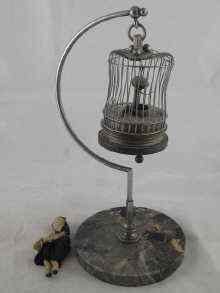 Appraisal: A hanging birdcage clock AF circa together with a small