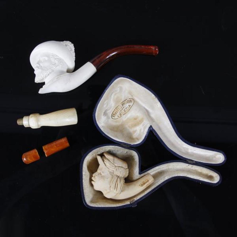 Appraisal: TWO MEERSCHAUM AFRICAN FIGURAL PIPES WITH EXTRA STEMS MAN IN