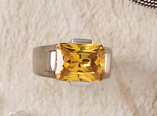 Appraisal: SILVER RING Sterling ring with golden color faceted rectangular step