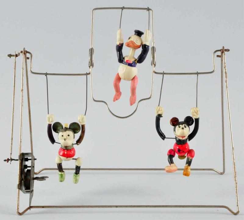 Appraisal: Celluloid Triple Character Trapeze Wind-Up Toy Description Japanese Circa s